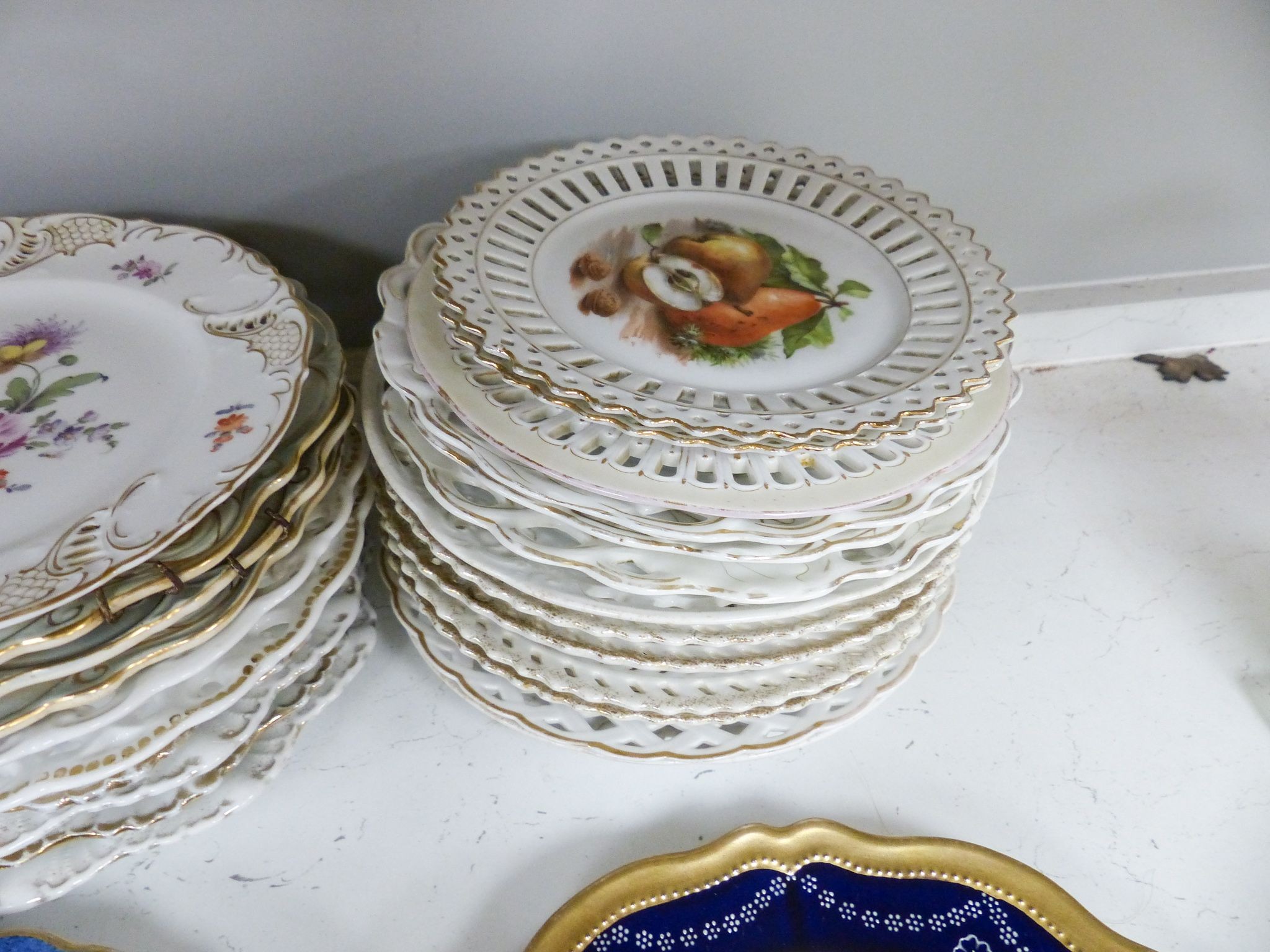 A collection of 19th/20th century Continental porcelain wall plates including a Royal Worcester powder blue fruit painted plate signed W. Bee, 23cm